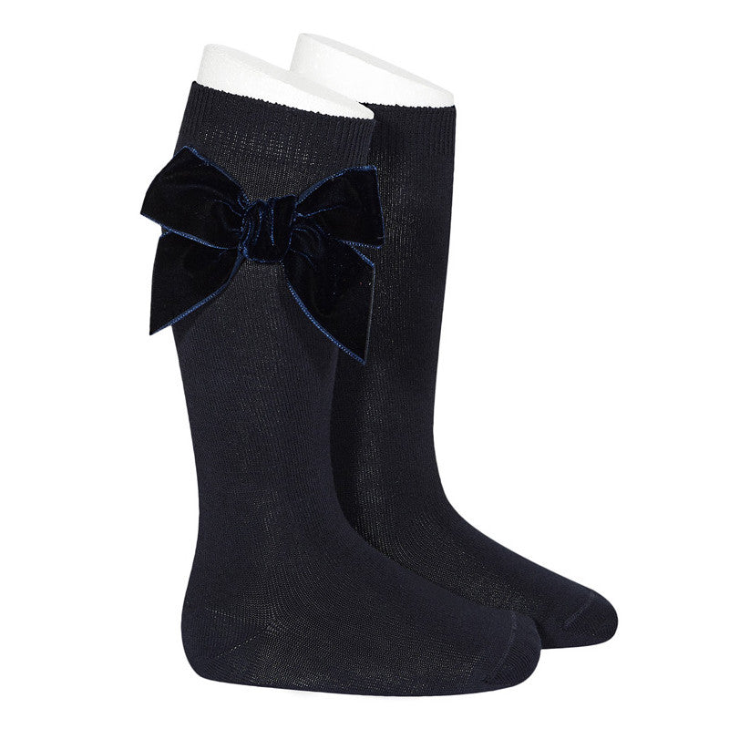 Side view of Condor girls navy knee high socks showing velvet bow detail