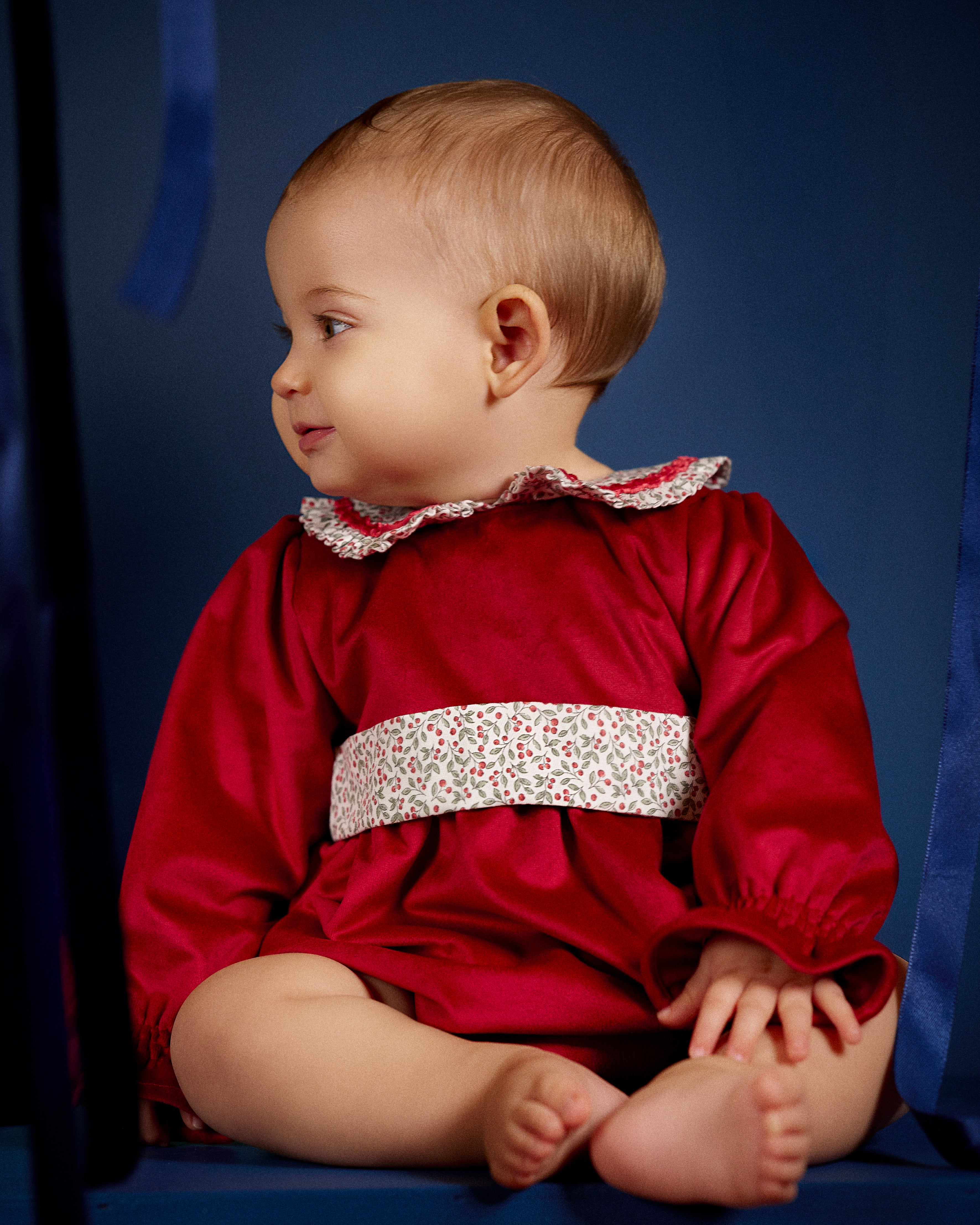 Baby girl wearing Deolinda Frosty festive red romper side view