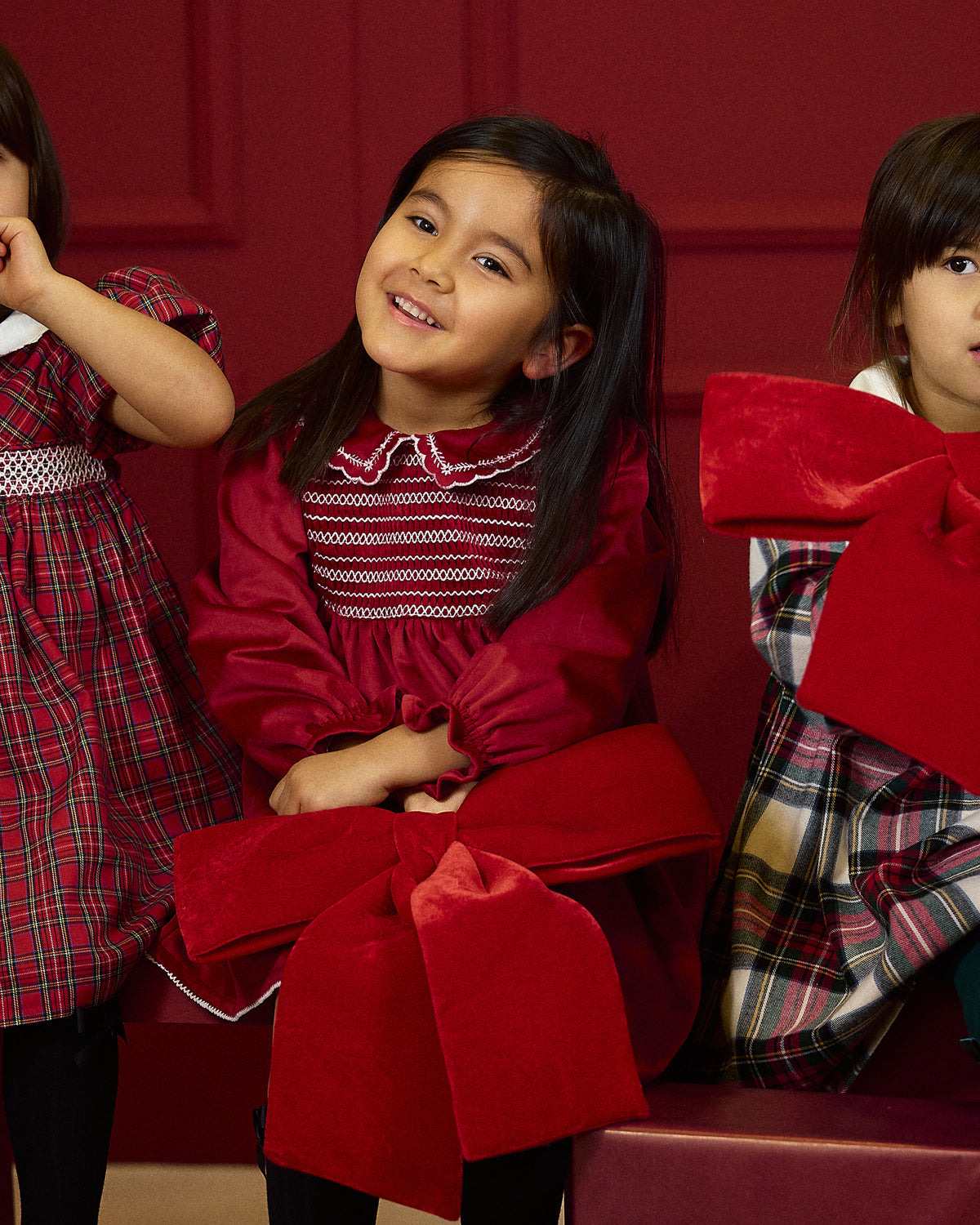Deolinda Jolly girls red Christmas day dress in festive campaign setting