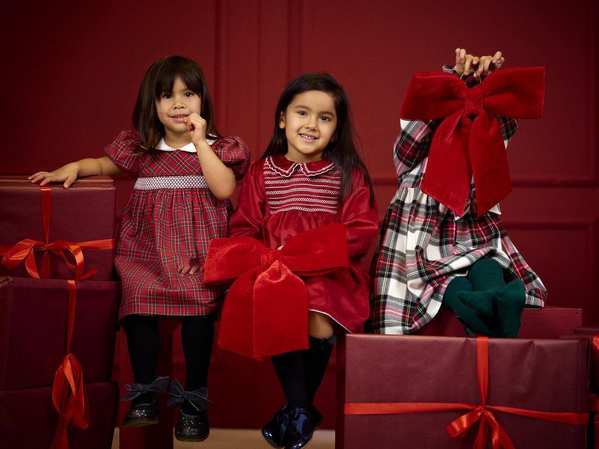 Deolinda Noelle girls tartan Christmas dress in festive campaign setting