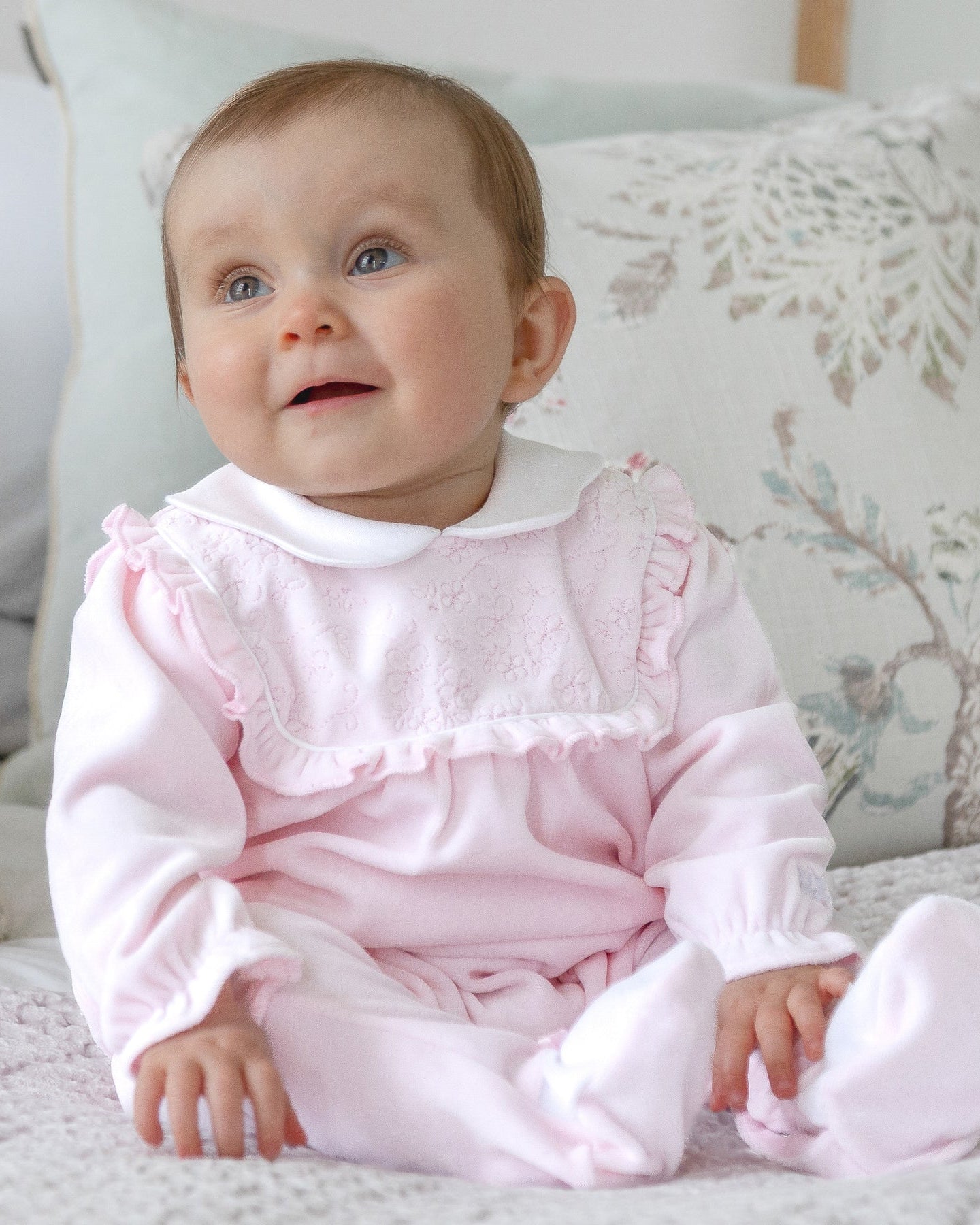 Baby girl wearing Emile et Rose Maddy pale pink velour babygrow