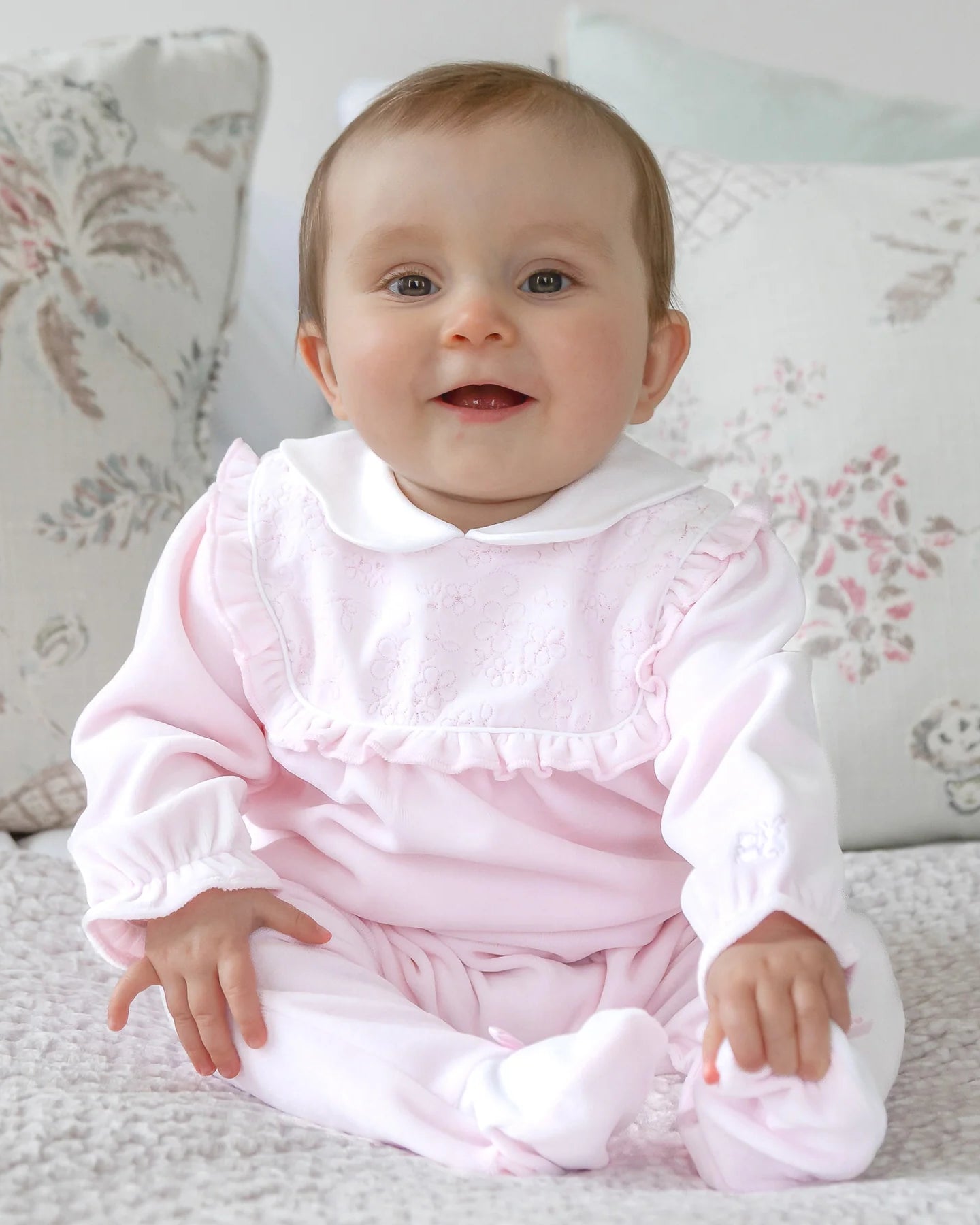 Baby girl wearing Emile et Rose Maddy pale pink velour babygrow