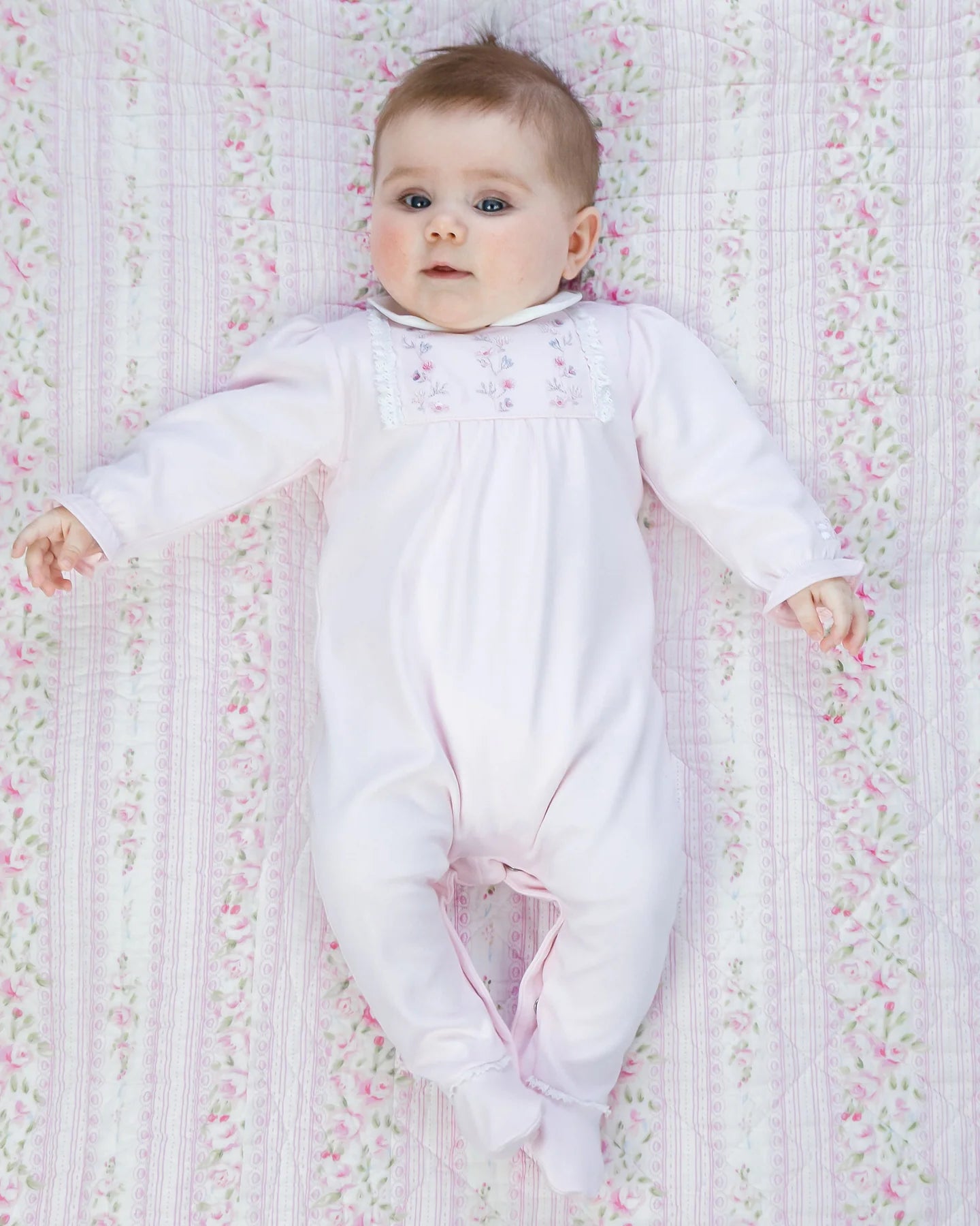Baby girl wearing Emile et Rose Madeleine pale pink velour babygrow