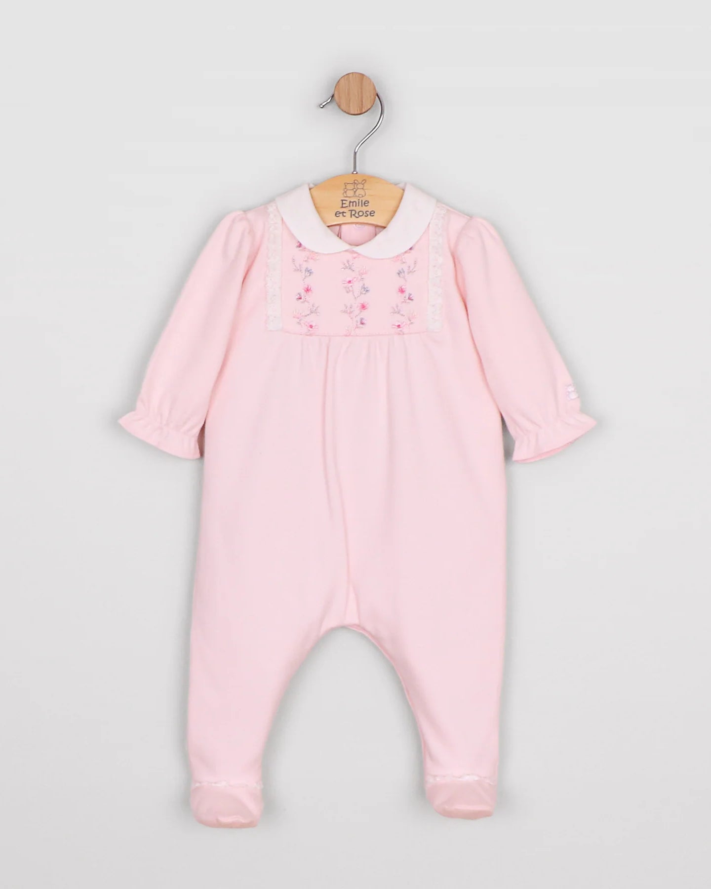 Baby girl in Emile et Rose Madeleine pink babygrow showing full outfit from front