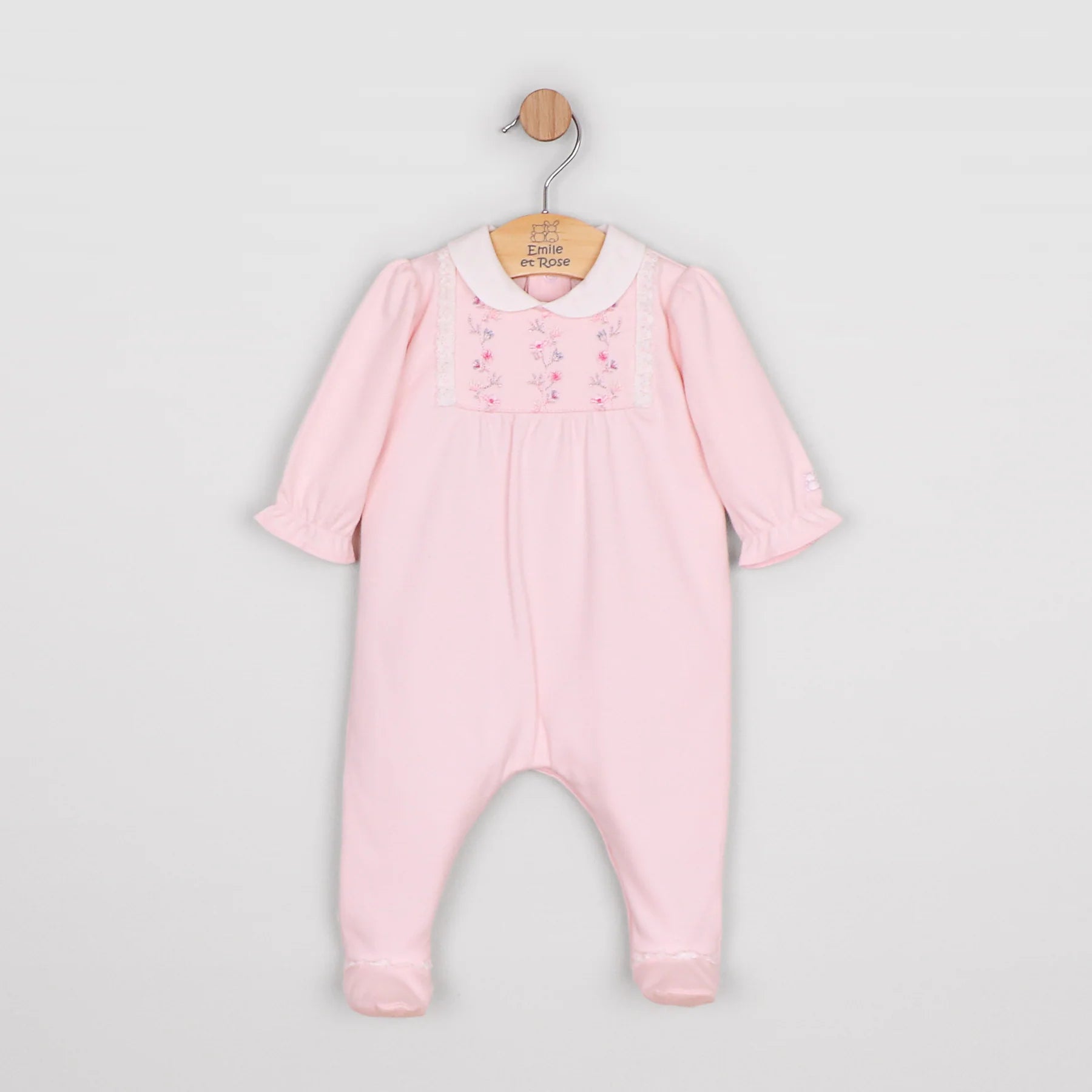 Baby girl in Emile et Rose Madeleine pink babygrow showing full outfit from front