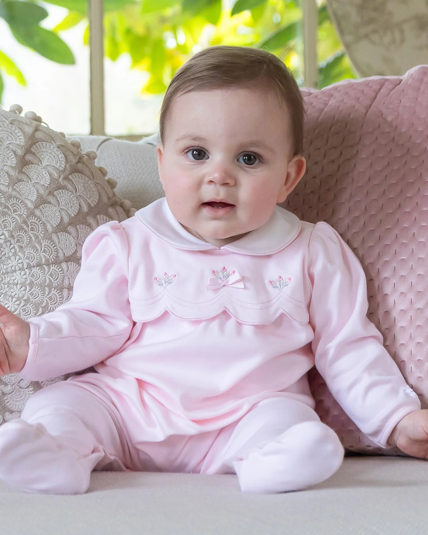 Baby girl wearing Emile et Rose Matilda pale pink romper and hat gift set