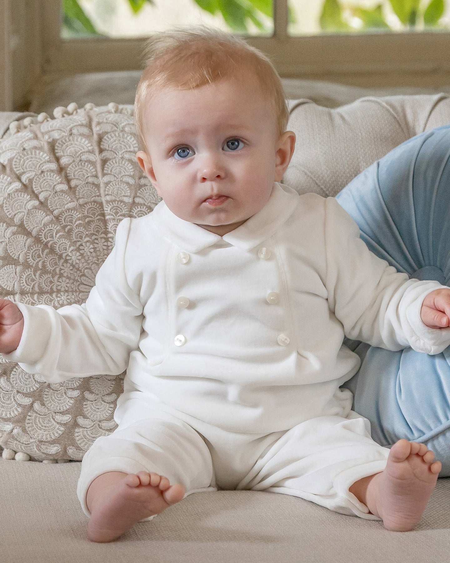 Baby boy wearing the Emile et Rose Marshall ivory velour occasion all in one romper