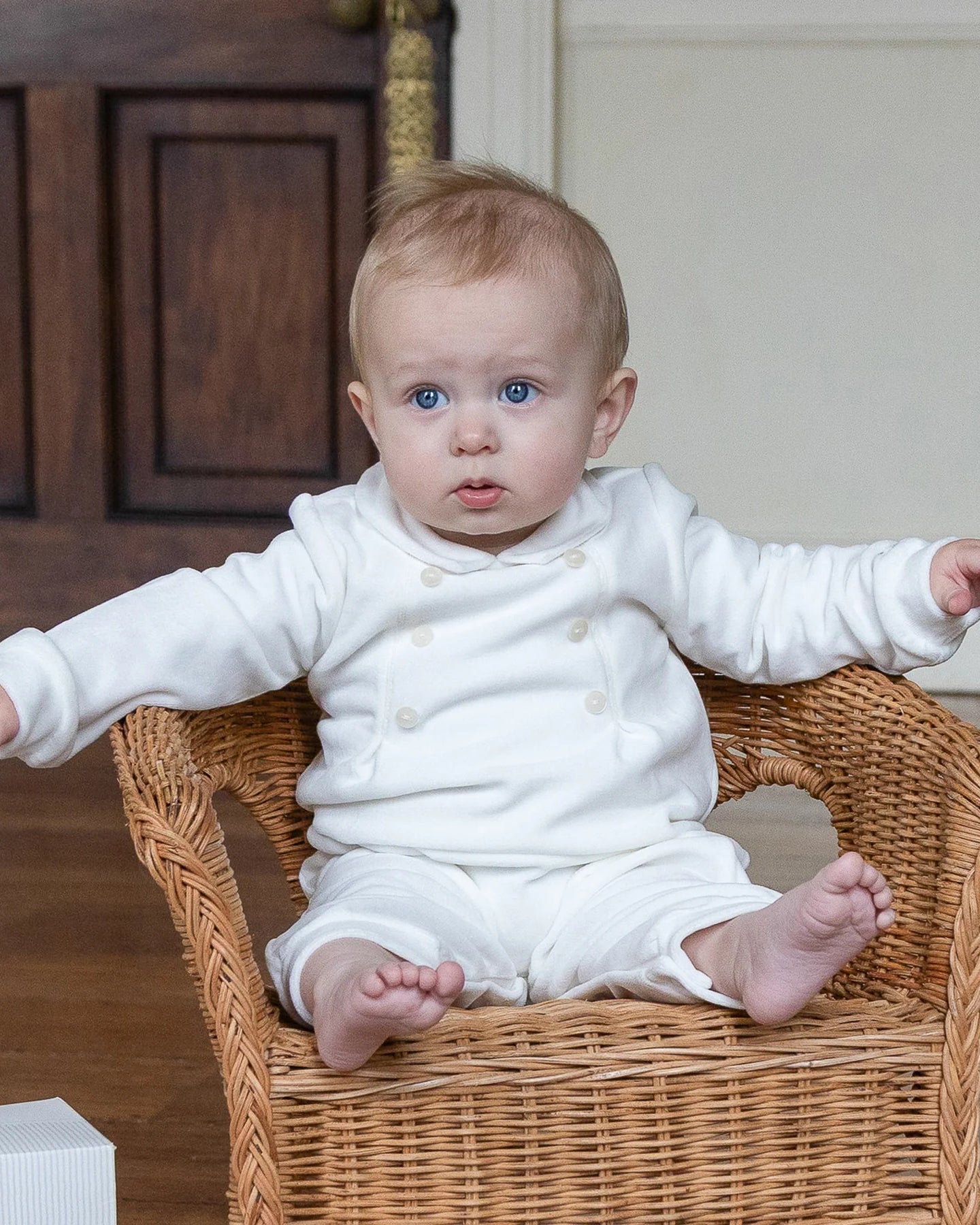 Baby boy wearing the Emile et Rose Marshall ivory velour romper while sitting
