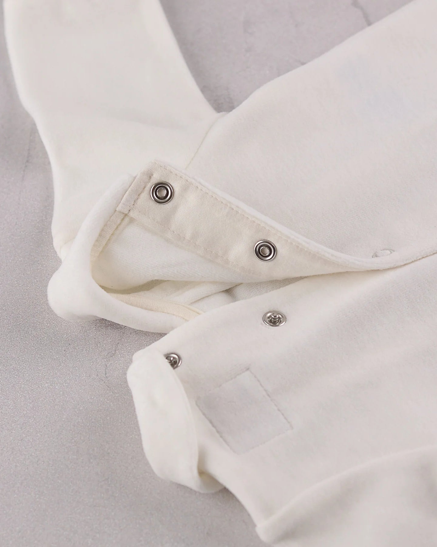 Close-up of the popper fastening on the Emile et Rose Marshall baby boys all in one occasion romper