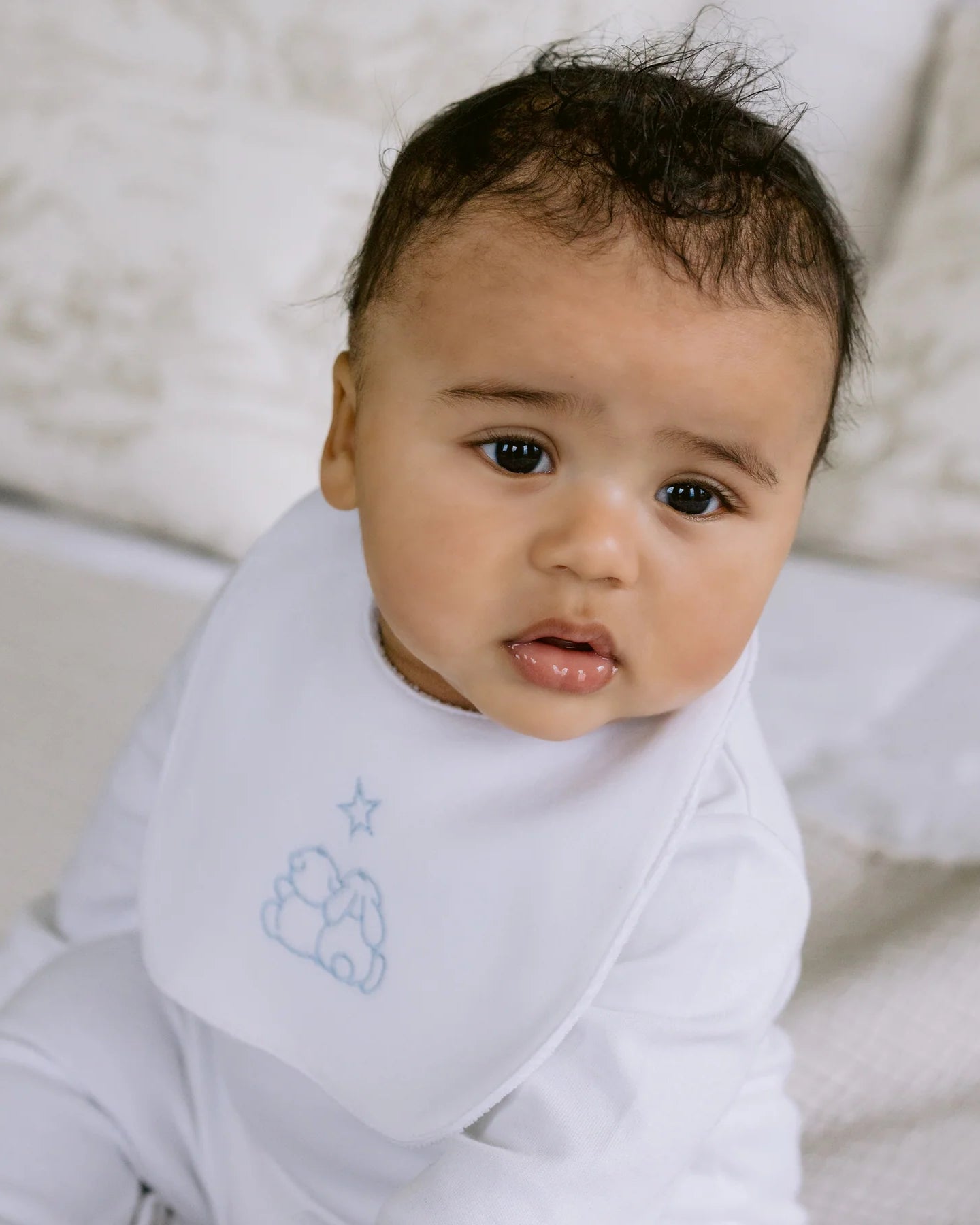 Baby boy wearing the Emile et Rose Trenton pale blue bib