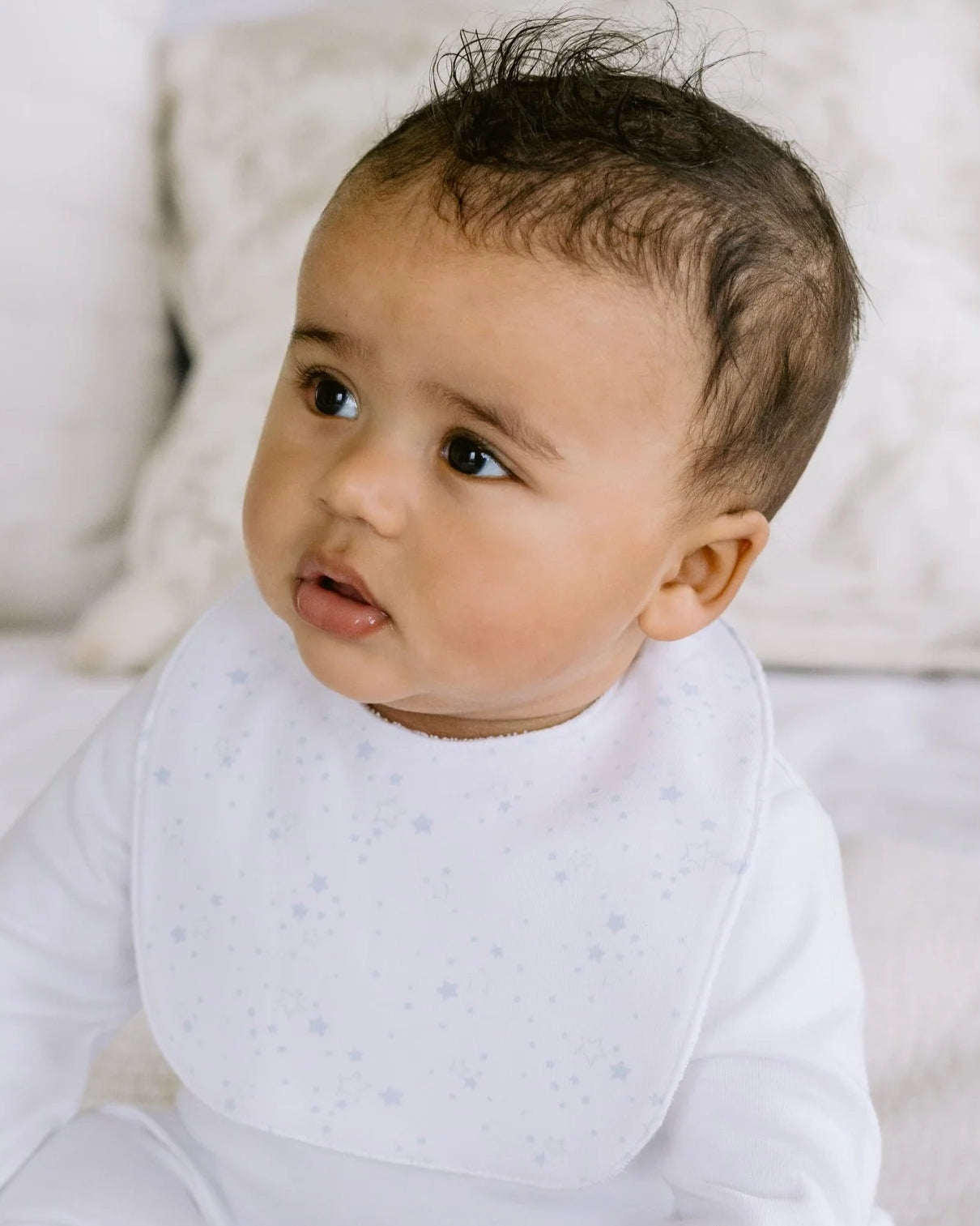 Baby wearing the Emile et Rose Trenton pale blue boys bib