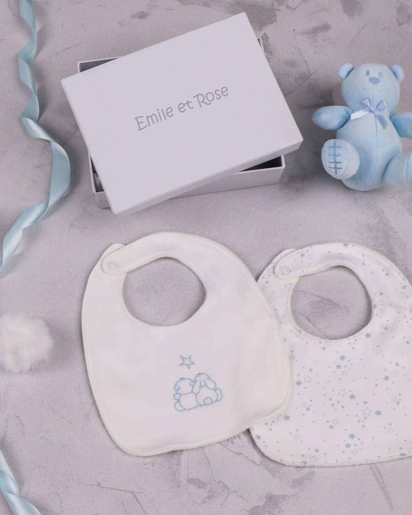 Emile et Rose Trenton pale blue teddy bear and two baby bibs with star print and embroidered design in a white gift box