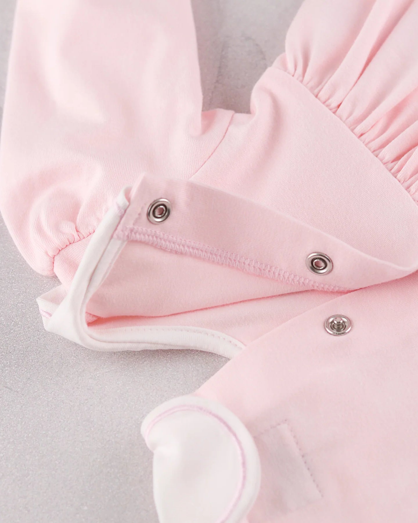 Back popper detail of the Emile et Rose Maggie pale pink baby dress