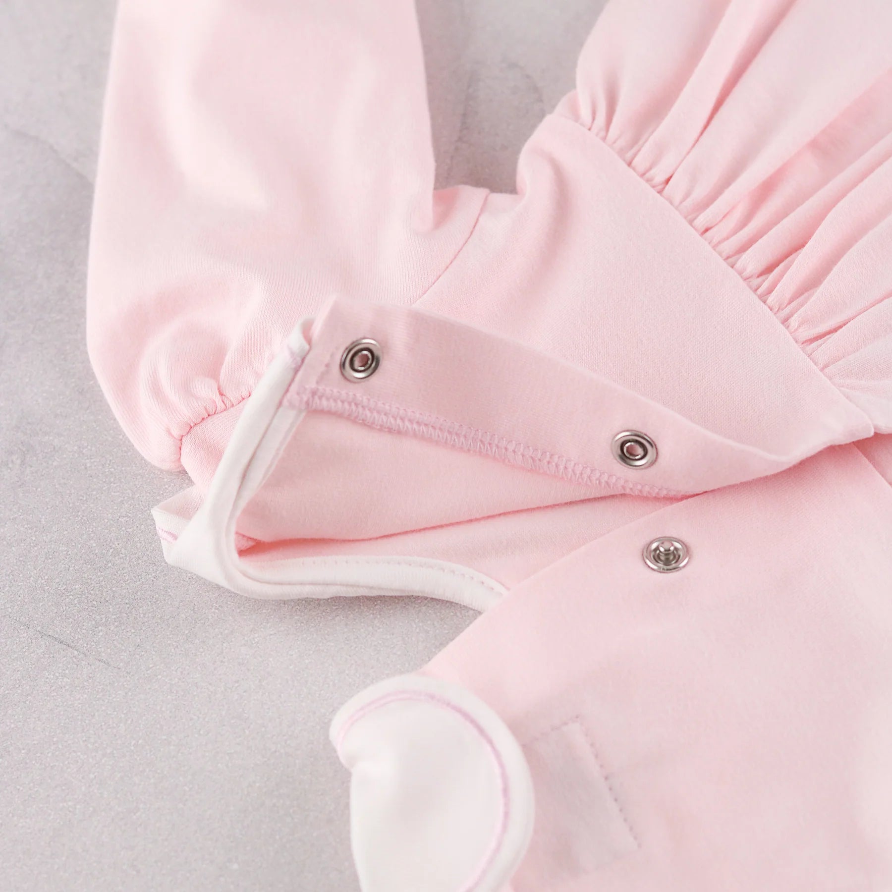 Back popper detail of the Emile et Rose Maggie pale pink baby dress