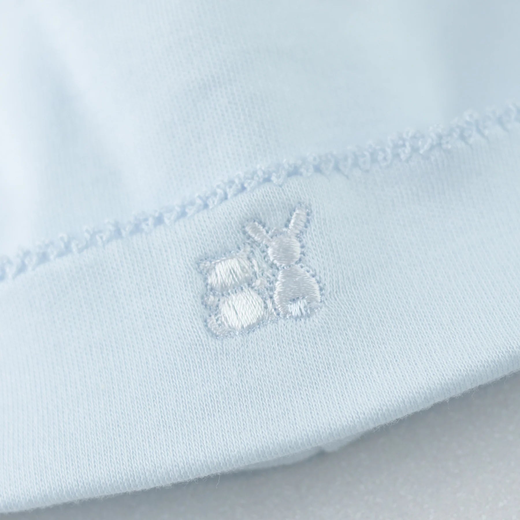 Embroidered toy motif close-up on Emile et Rose Kent babygrow.