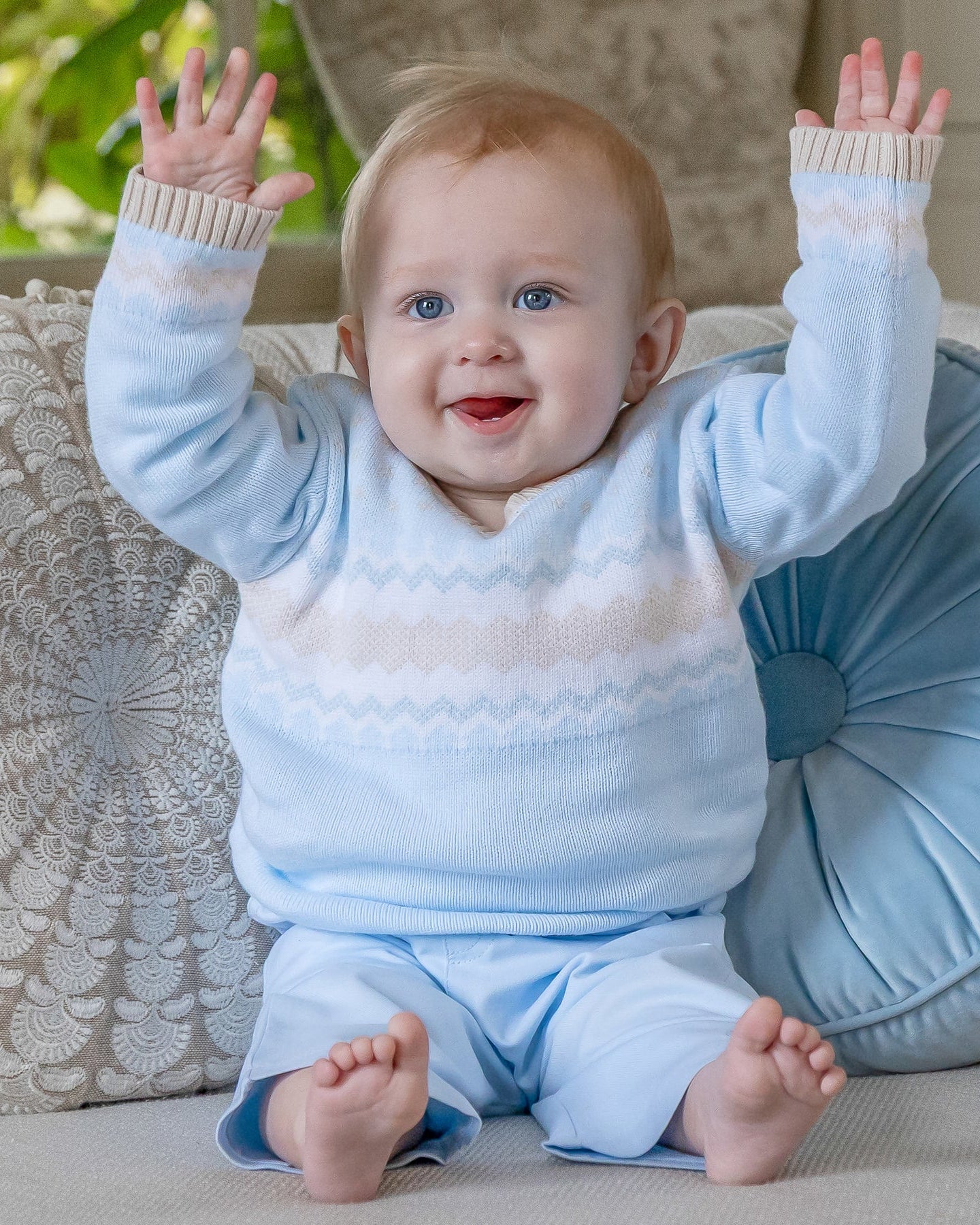 Baby boy wearing Emile et Rose Martin pale blue knitted outfit set