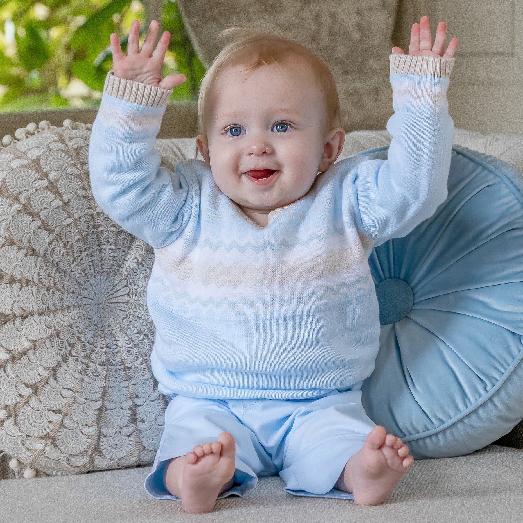 Baby boy wearing Emile et Rose Martin pale blue knitted outfit set