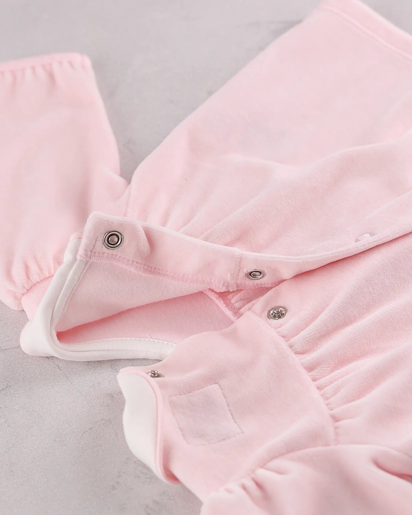 Back view of the Emile et Rose Michelle pale pink baby girls velour outfit showing popper fastening