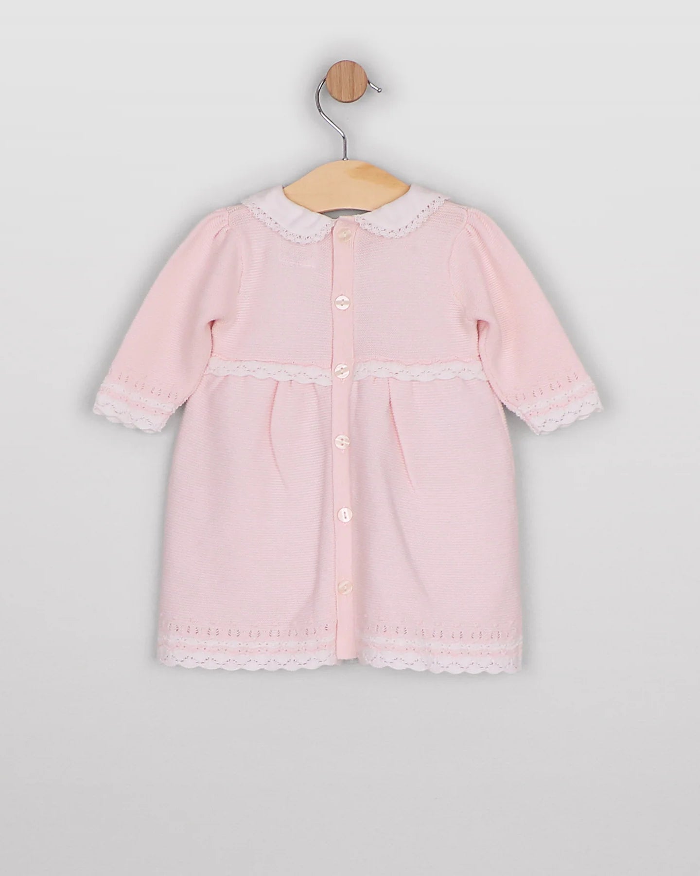Back view of the Emile et Rose Millie pale pink knitted baby girls dress