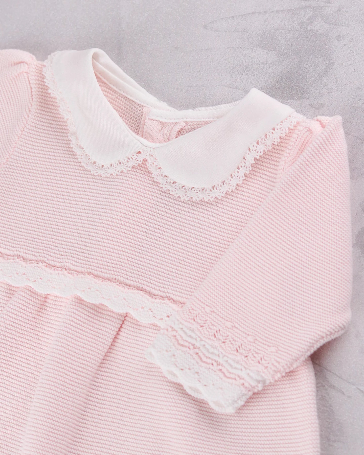 Close-up of the scalloped collar and crochet lace on the Emile et Rose Millie baby girls dress