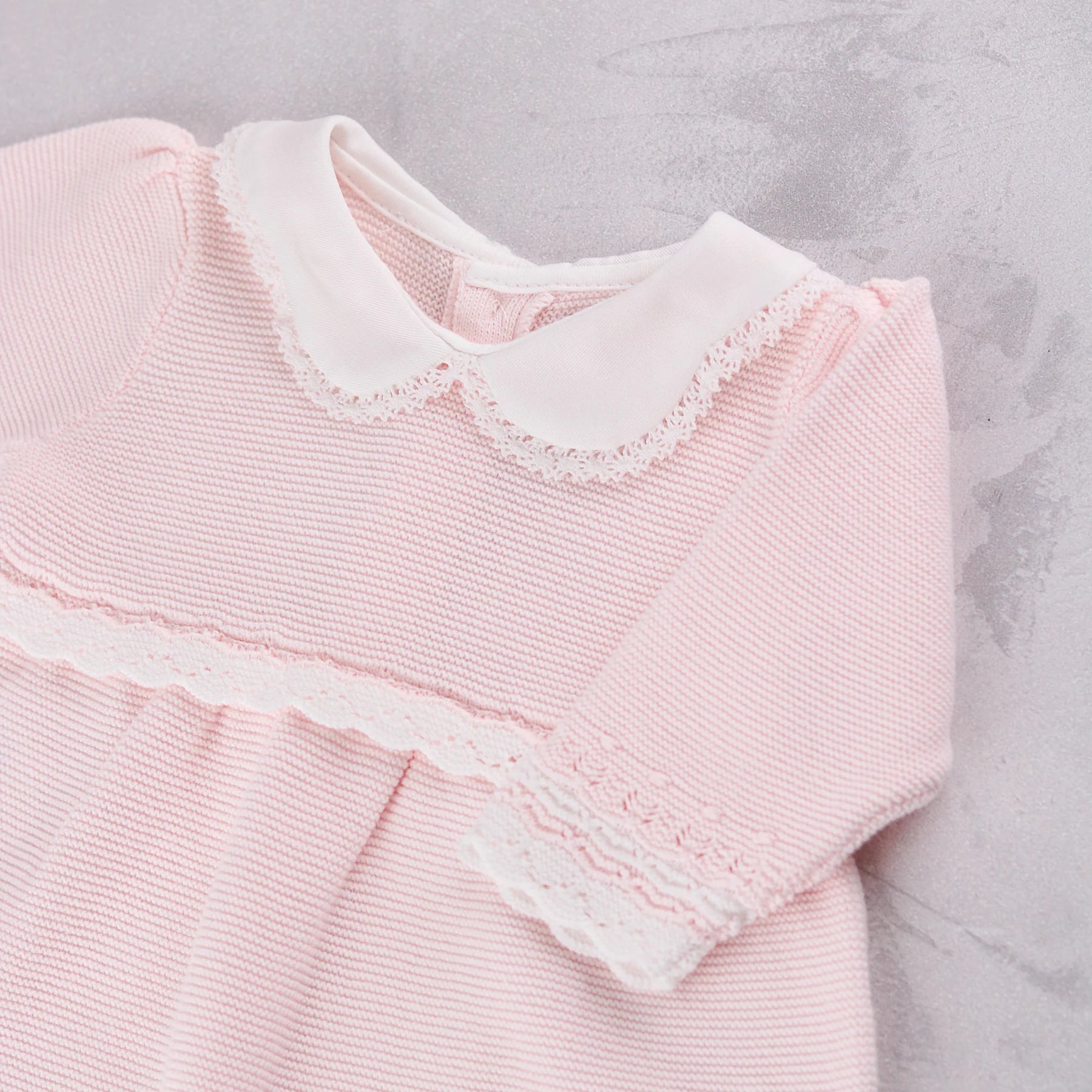 Close-up of the scalloped collar and crochet lace on the Emile et Rose Millie baby girls dress