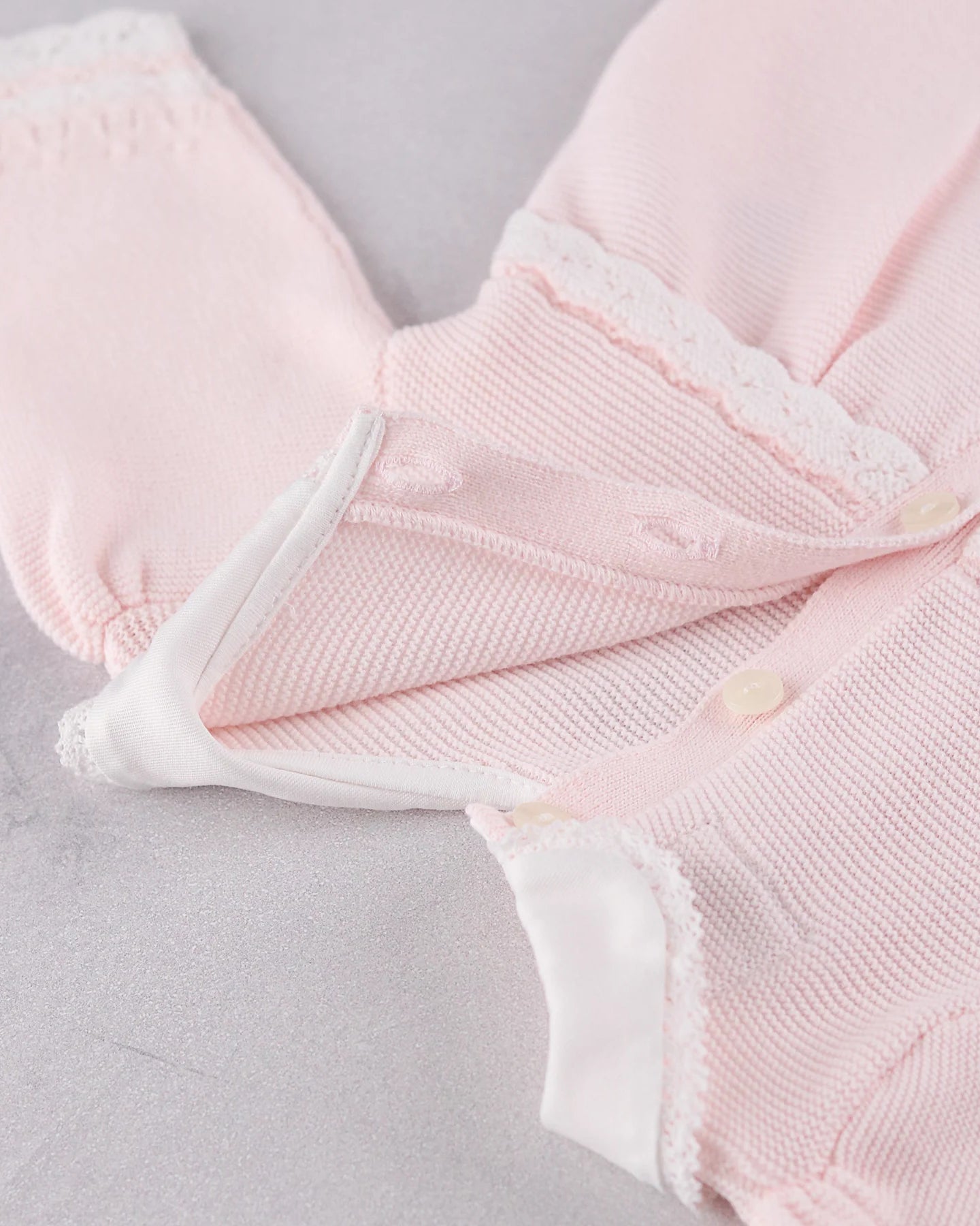 Close-up of the back button detail and on the Emile et Rose Pink Millie dress