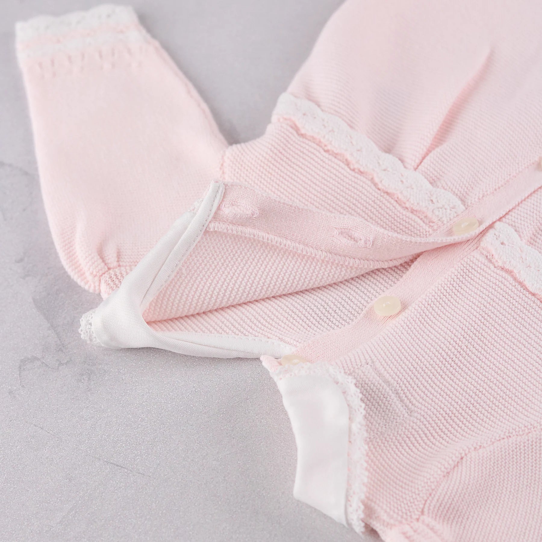 Close-up of the back button detail and on the Emile et Rose Pink Millie dress