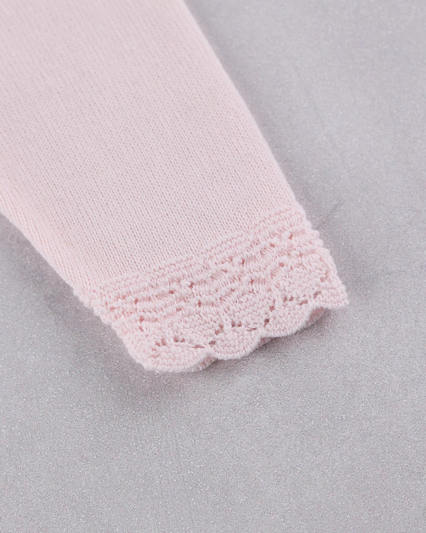 Close-up of the knitted pink lace cuff detail on the Emile et Rose Minny baby girls outfit