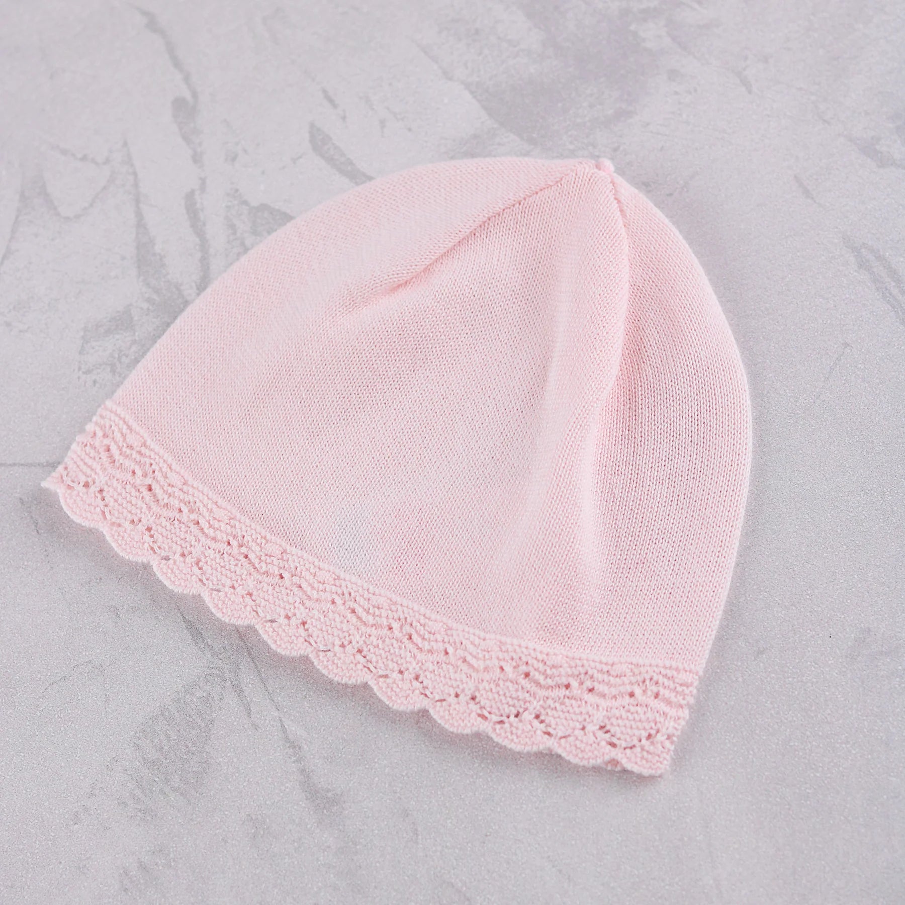 Matching pale pink knitted hat from the Emile et Rose Minny baby girls outfit set