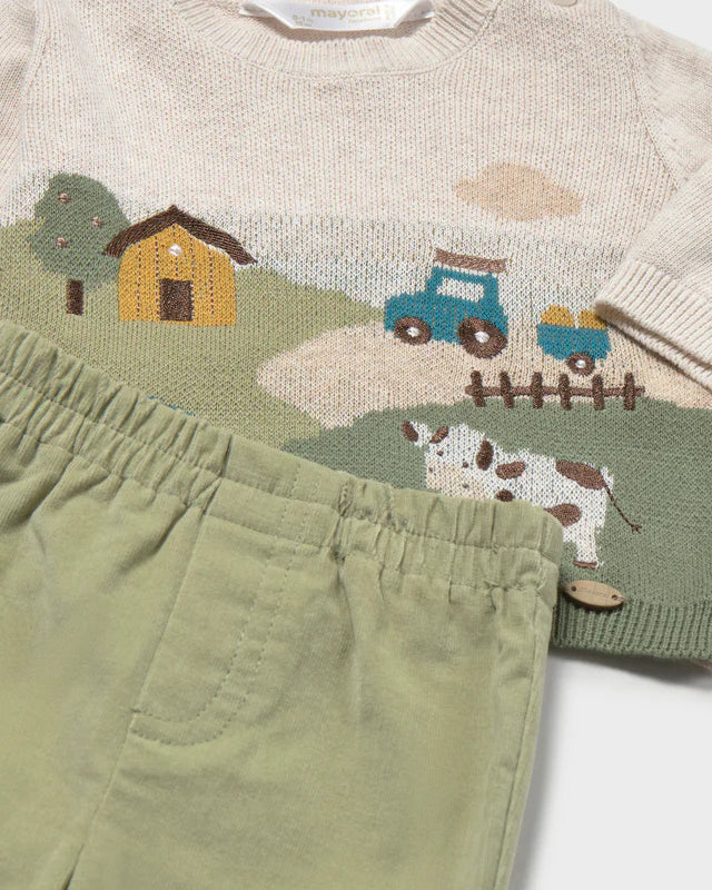 Close-up of Mayoral baby boys knitted farmhouse, tractor and cow jumper with green casual trousers
