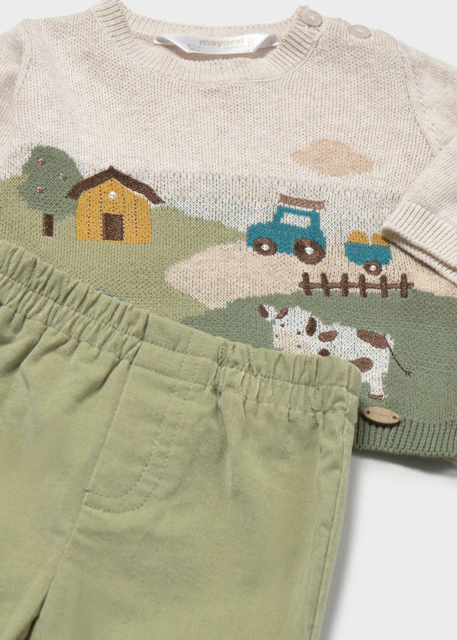 Close-up of Mayoral baby boys knitted farmhouse, tractor and cow jumper with green casual trousers