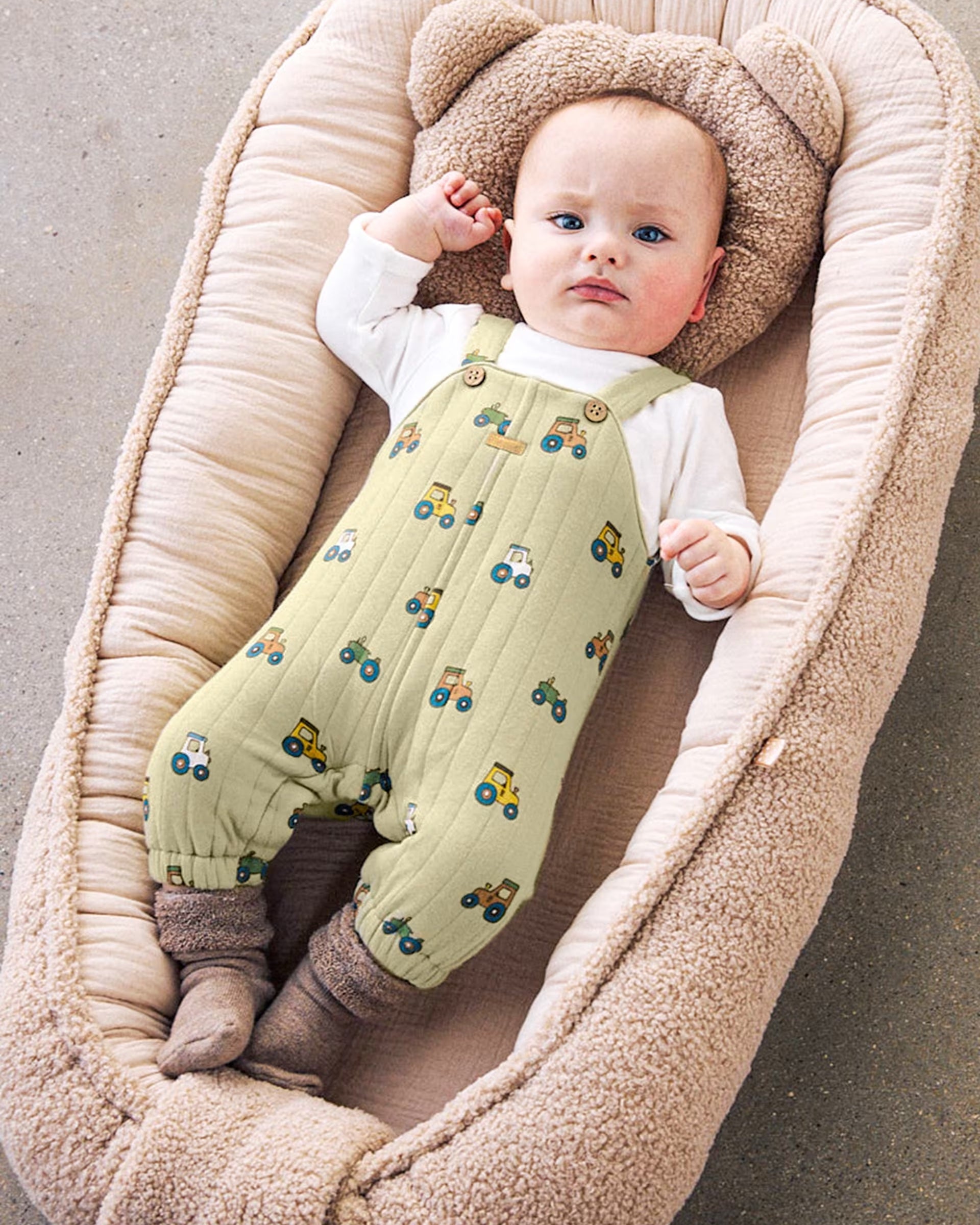Mayoral newborn baby boy wearing a green tractor dungaree set with cream long-sleeved top