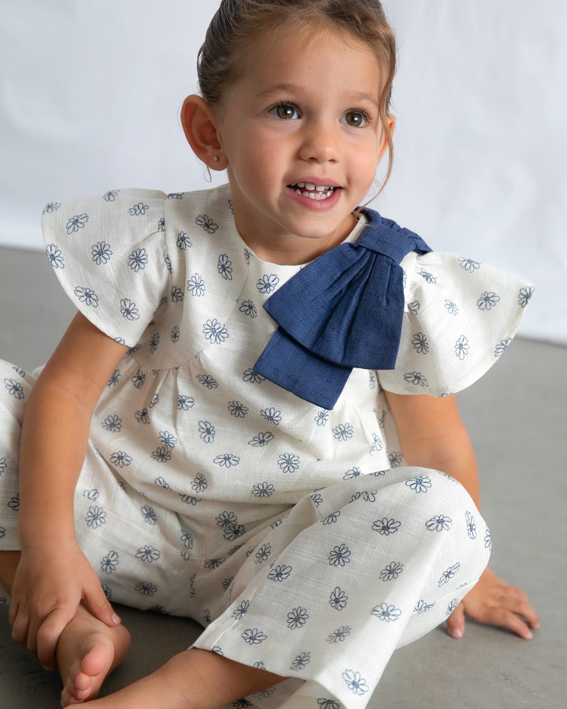 Mayoral girls daisy print outfit set worn close up blue bow detail