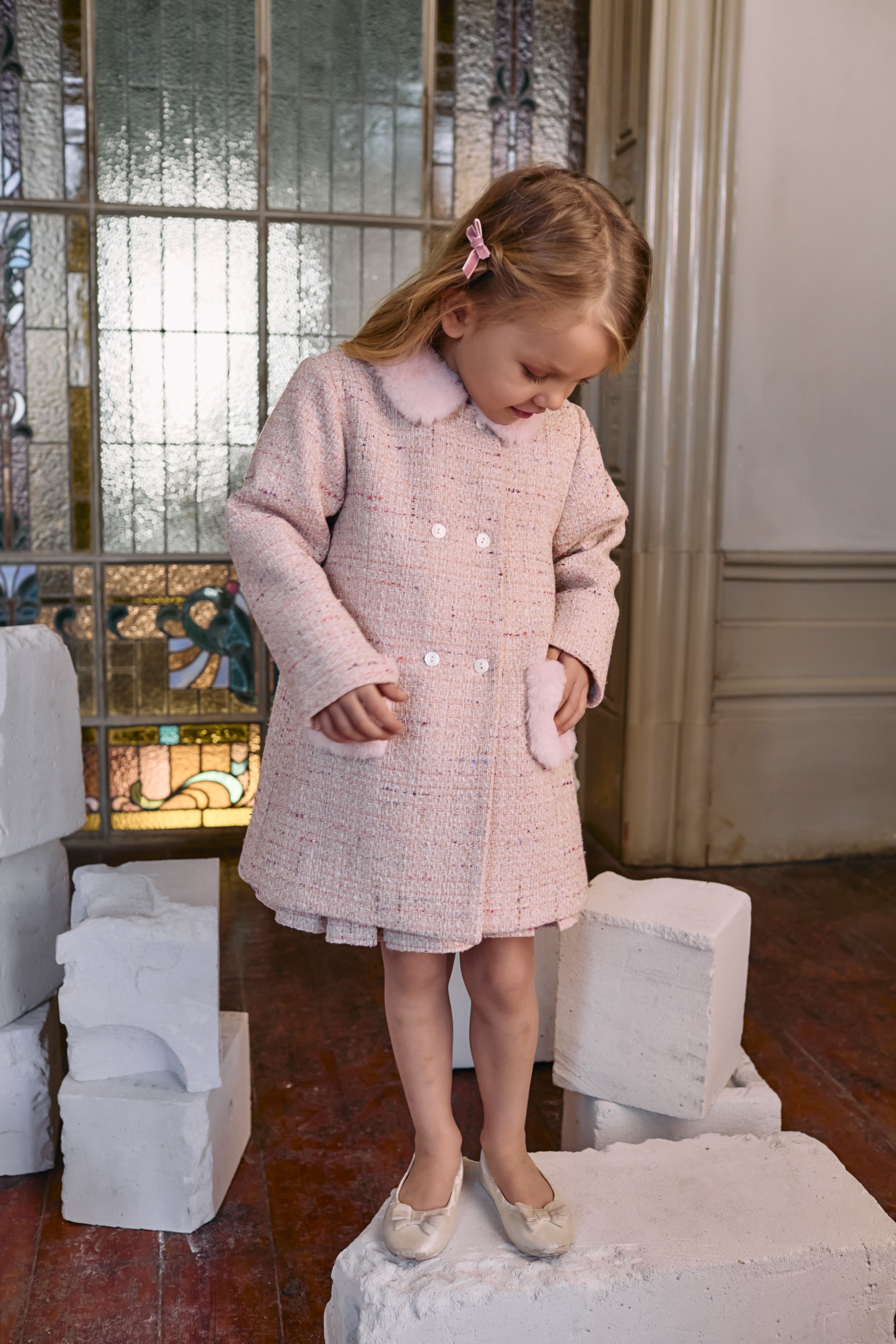Girl aged 5 wearing Patachou
pink tweed coat with faux fur trim