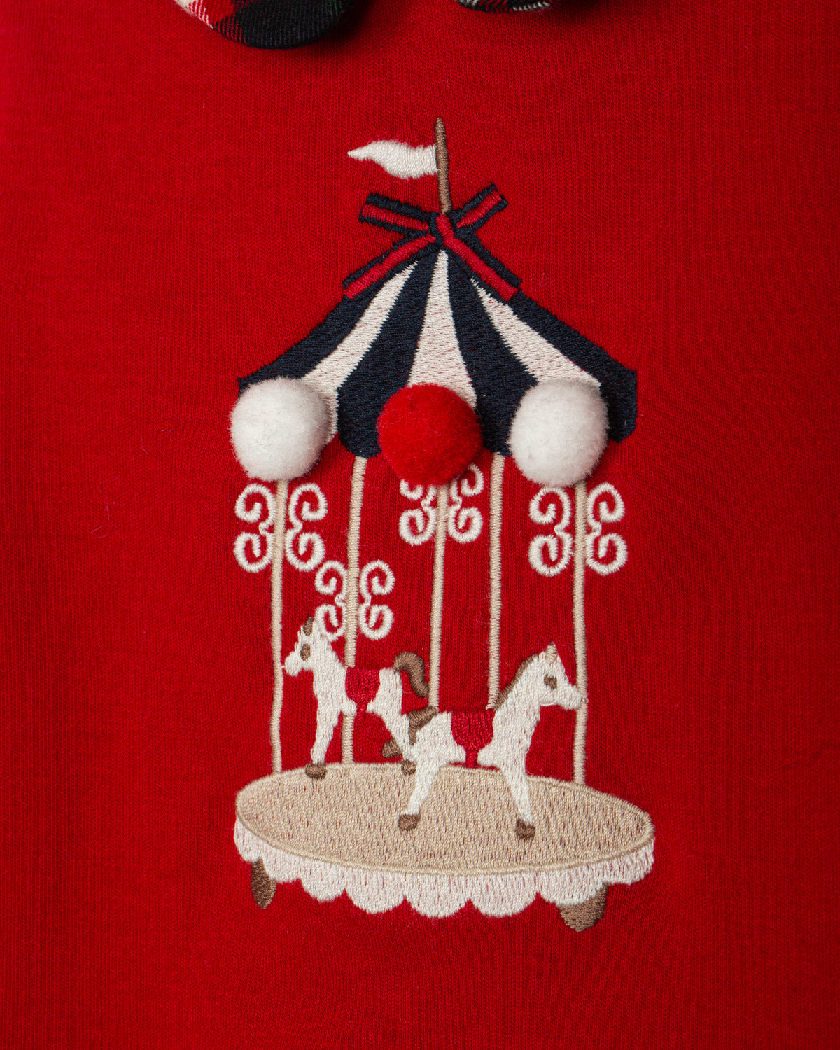 Girl wearing Patachou red carousel and tartan Christmas dress