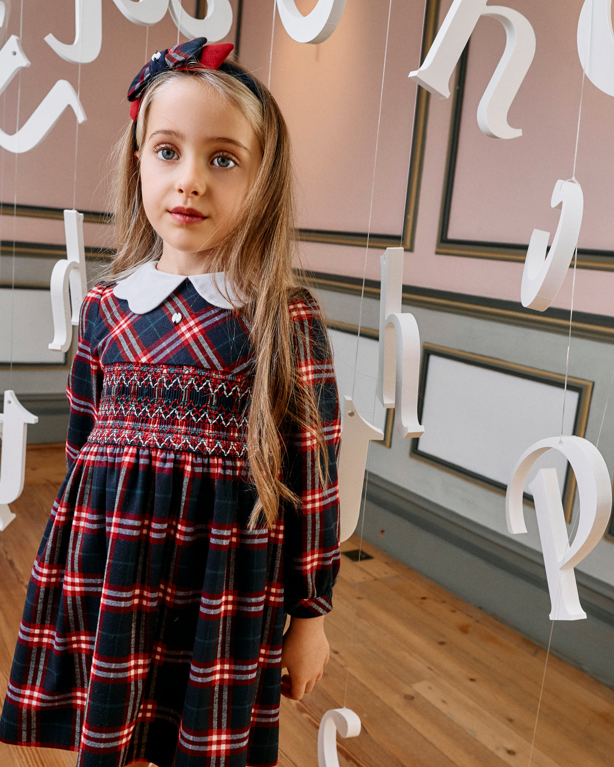 Girl wearing Patachou Balmoral red and navy tartan smocked dress