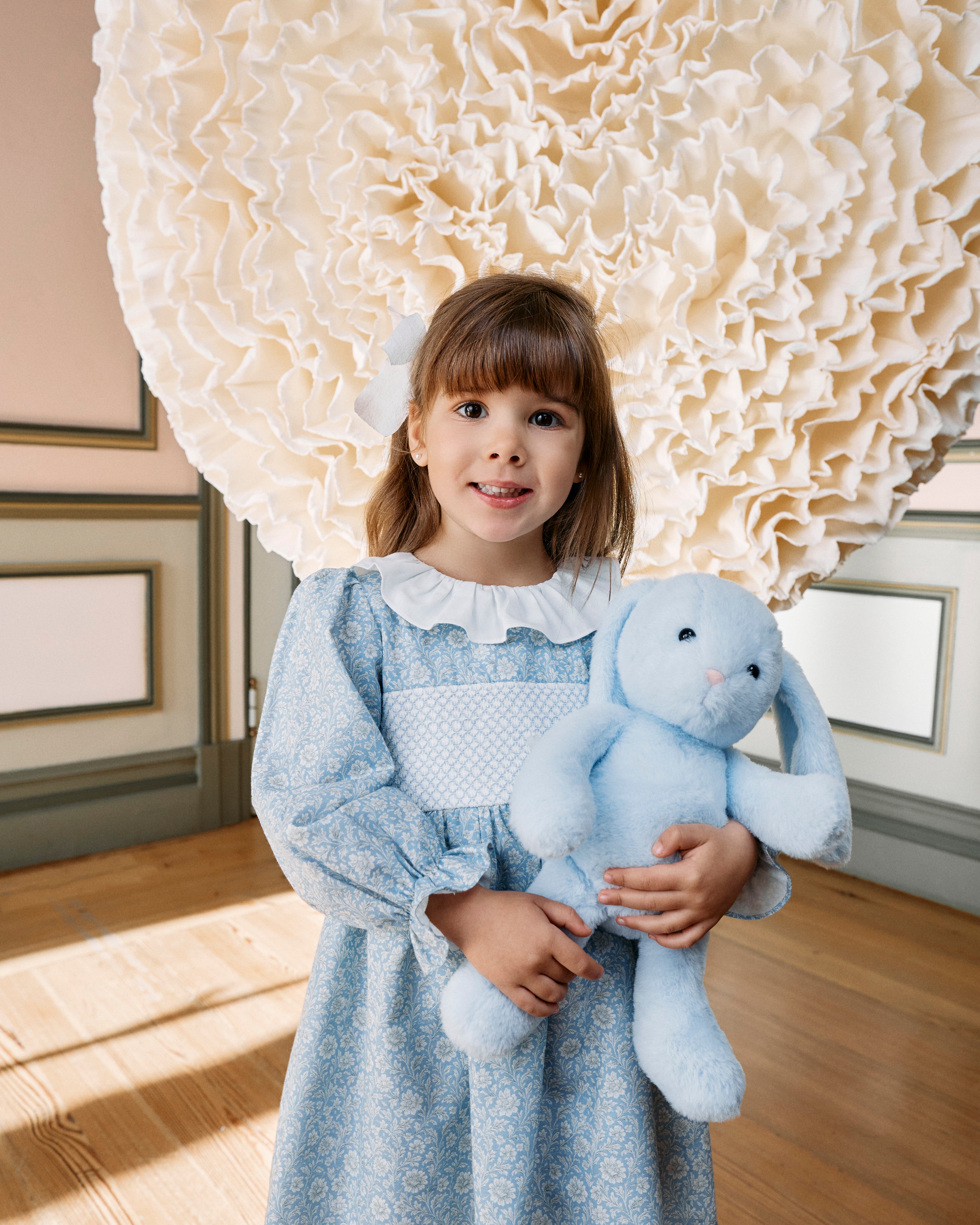 Girl wearing Patachou blue floral smocked cotton dress