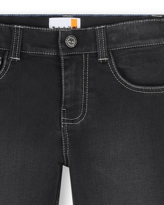 Close-up of Timberland boys black jeans showing waistband, button fastening and contrast stitching