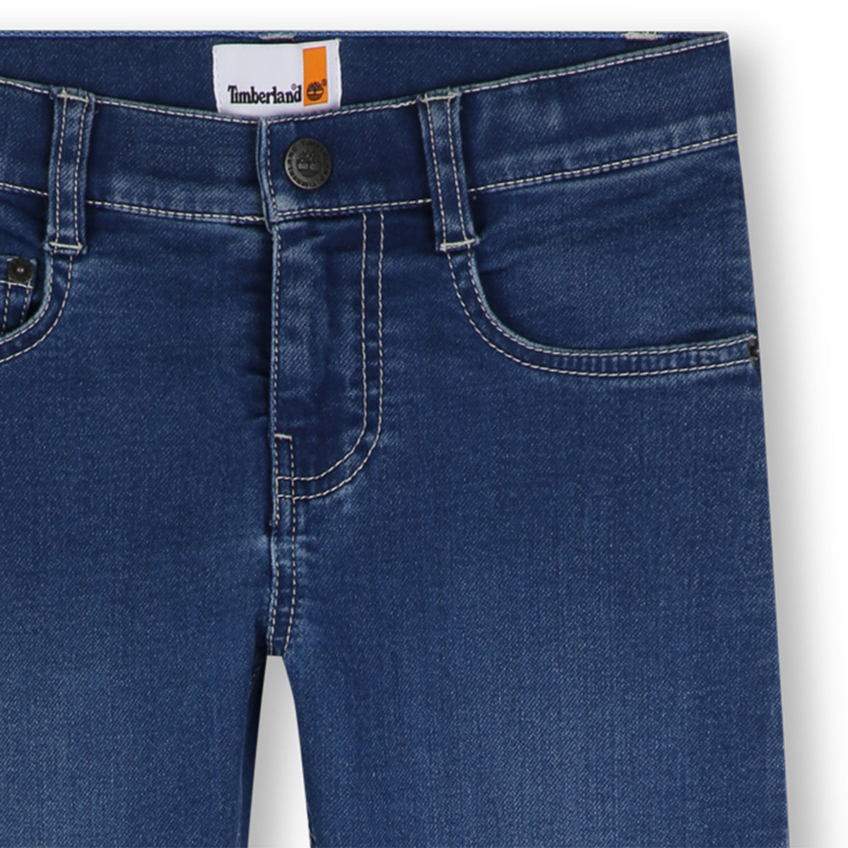 Close-up of Timberland boys blue jeans showing waistband, button fastening and contrast stitching