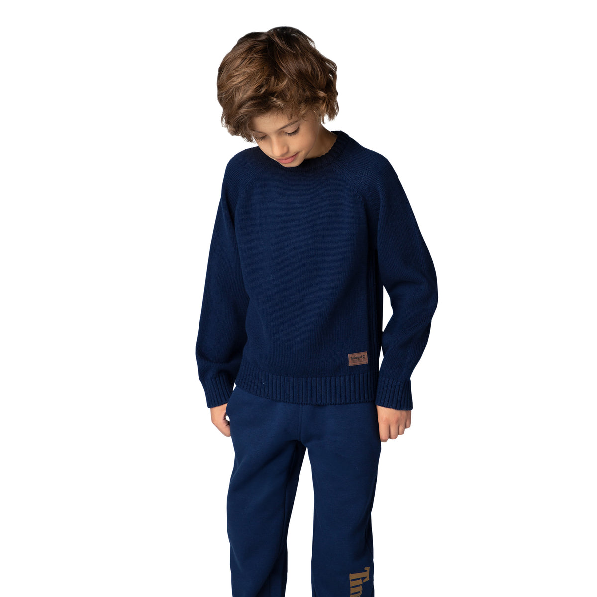 Boy wearing Timberland navy blue cotton and wool knitted jumper front view