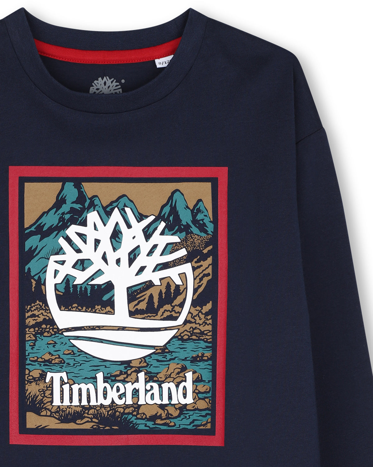 Close-up of Timberland tree logo on boys navy graphic long sleeve T-shirt