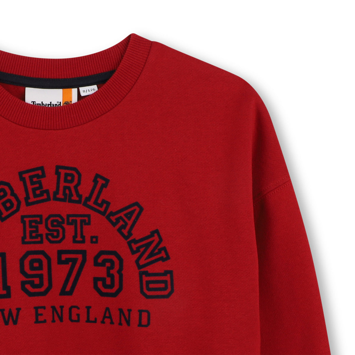 Close-up of Timberland 1973 New England logo on red boys sweatshirt