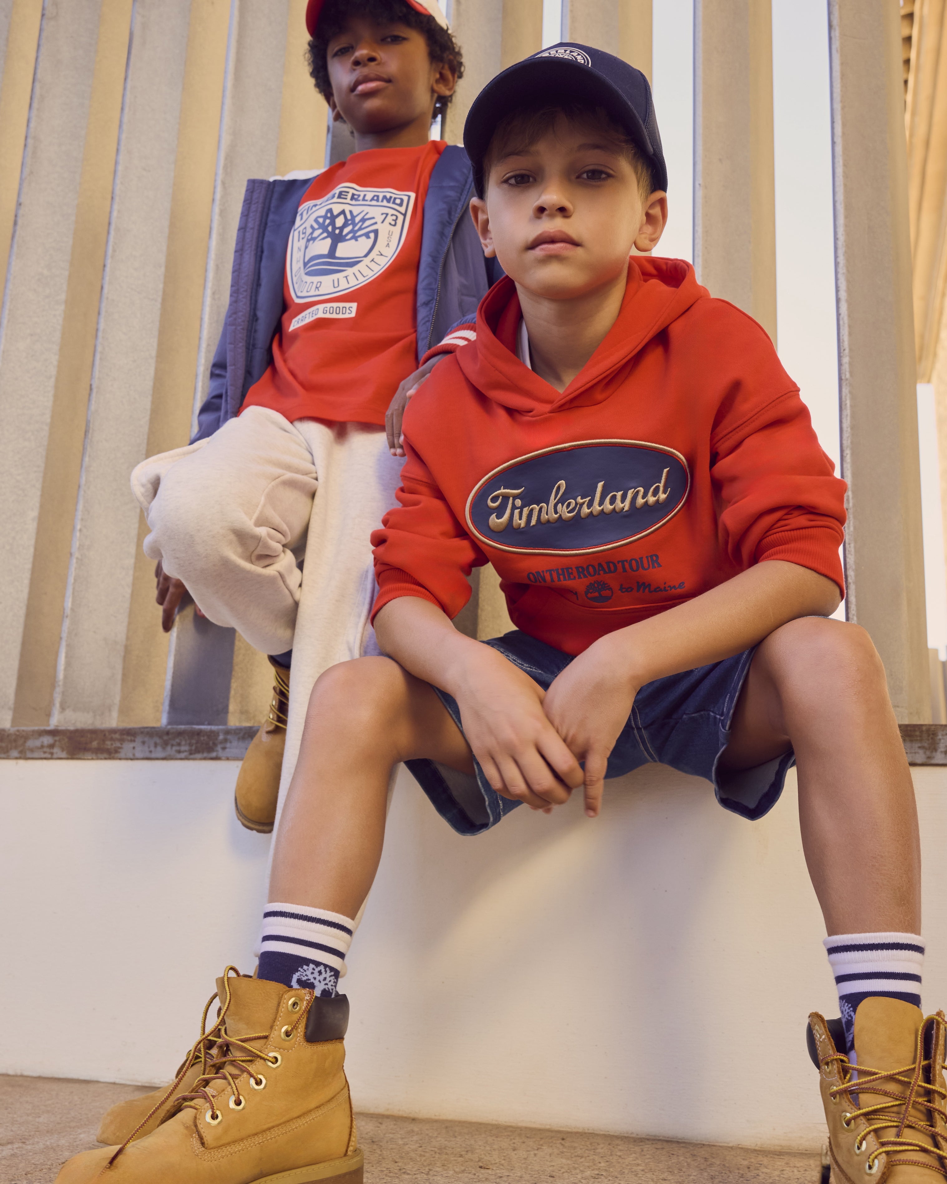 Timberland boys red summer T-shirt worn with casual shorts
