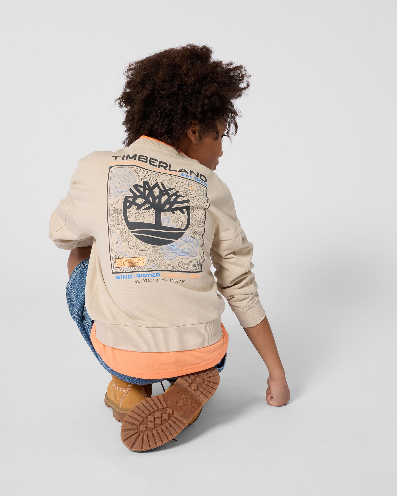 Timberland boys beige Timberland sweatshirt back view worn with jeans