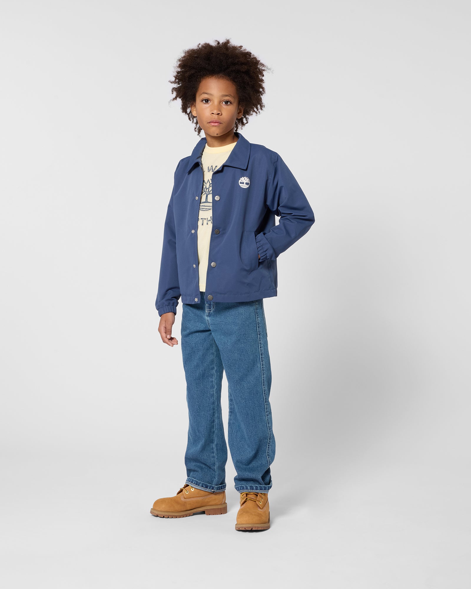 Timberland boys navy button jacket styled with jeans