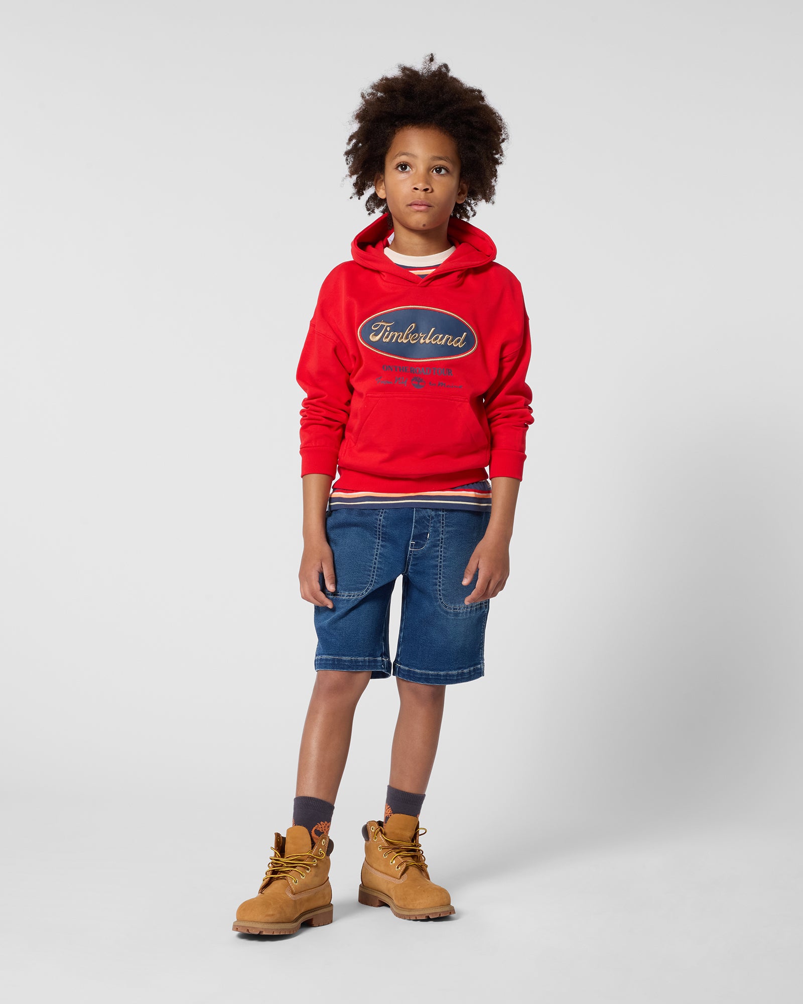 Timberland boys denim Bermuda shorts styled with red sweatshirt