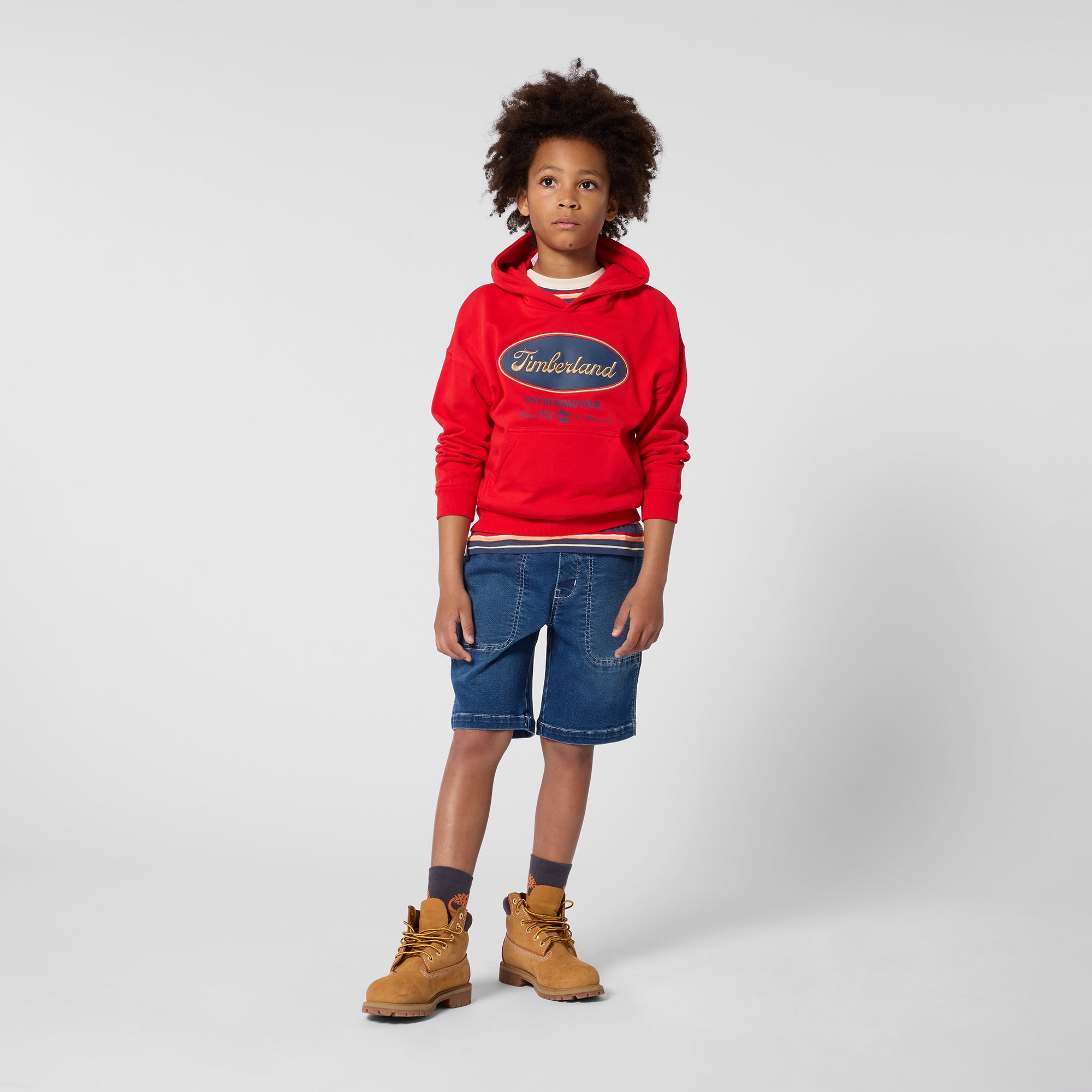 Timberland boys denim Bermuda shorts styled with red sweatshirt