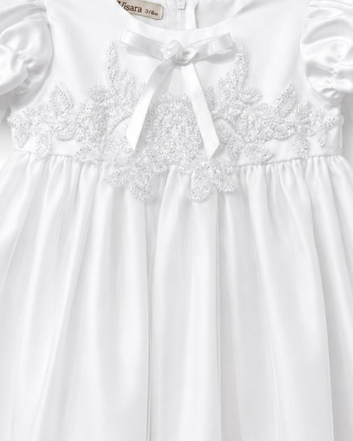 Close-up of the lace embroidered bodice and satin neckline bow on the Visara christening gown