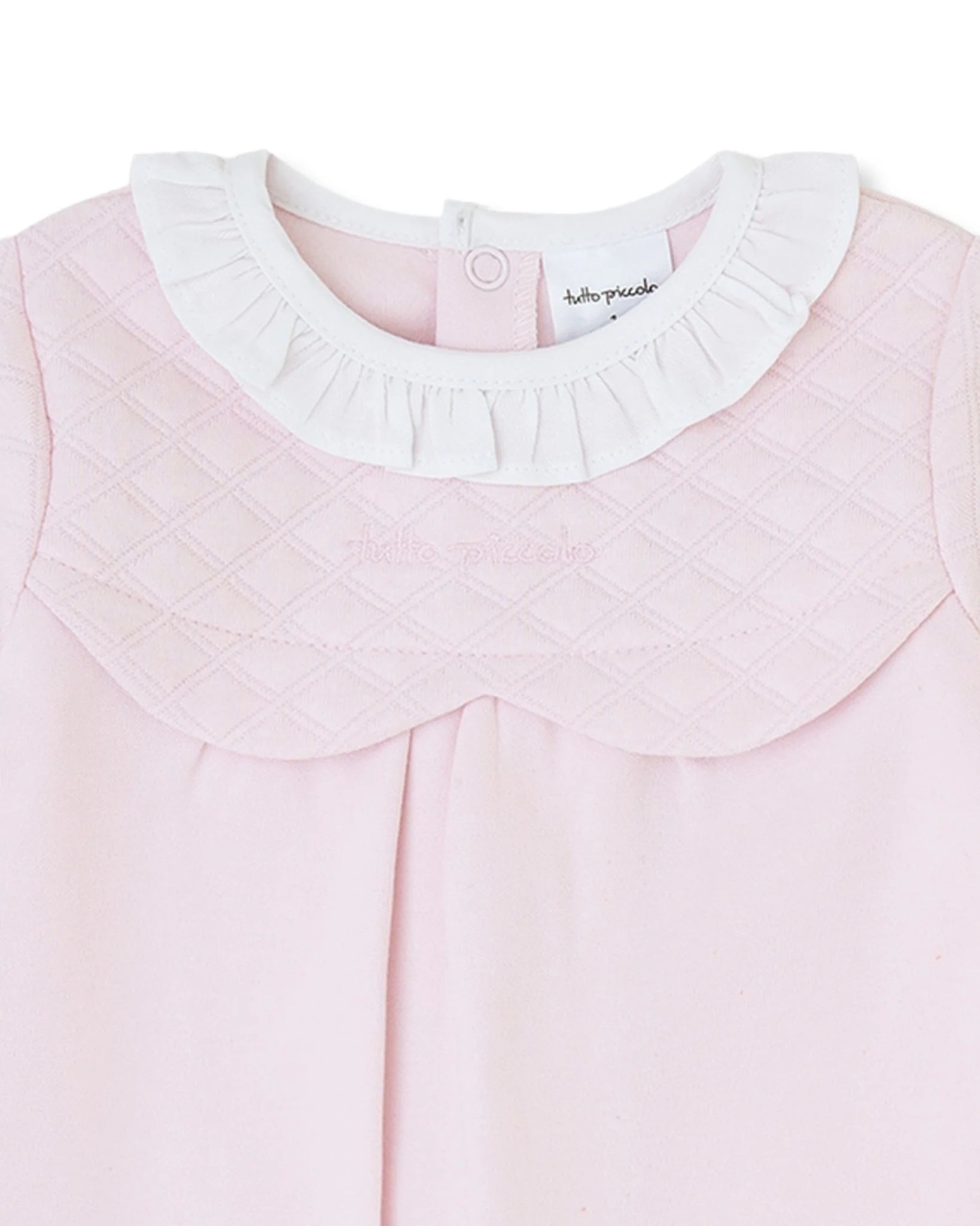 Close-up of Tutto Piccolo pink baby romper ruffle collar and padded yoke