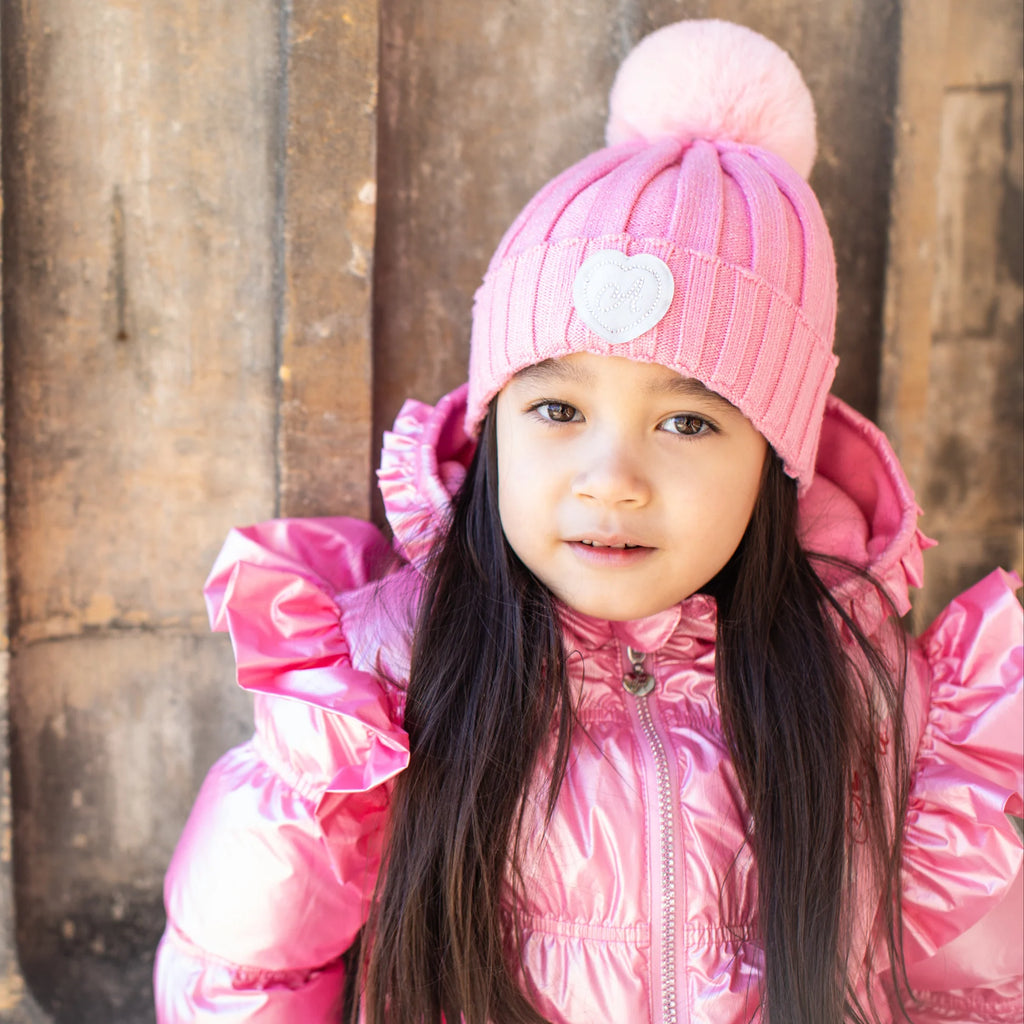 A Dee Mallory pink bobble hat with heart logo for girls aged 2-12 years